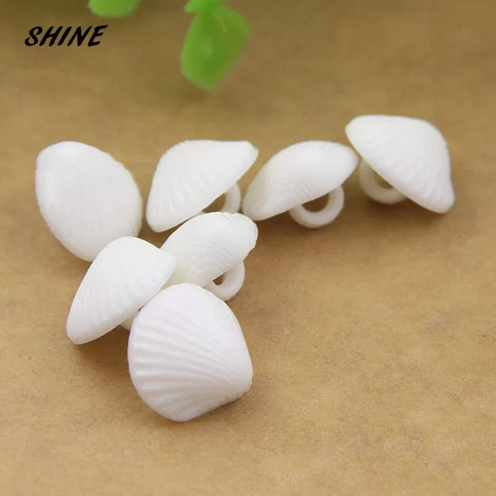 4 boutons en acrylique coquillage